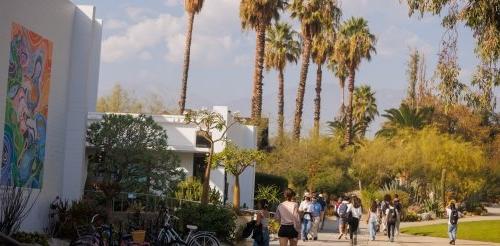 Wide campus view of people walking.